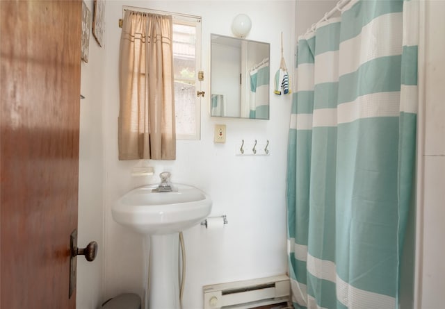 29276 White Swan Rd, Polson, MT 59860 - full bath featuring a baseboard radiator and a shower with curtain