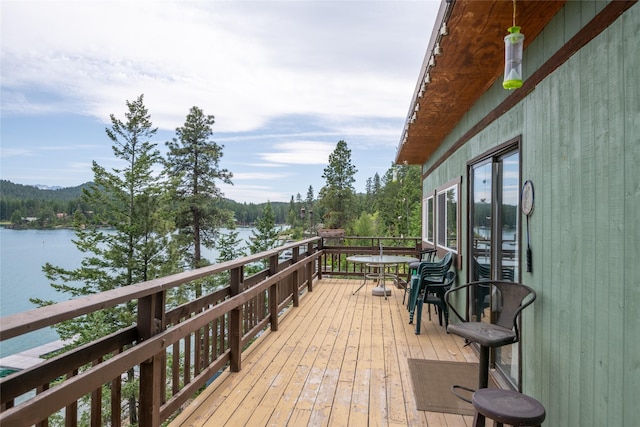 29276 White Swan Rd, Polson, MT 59860 - wooden terrace featuring a water view and outdoor dining area