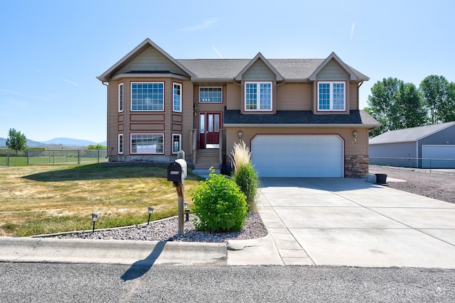 5835 Winter Wheat Dr, Helena, MT 59602 - split foyer home featuring a garage, driveway, and a mountain view