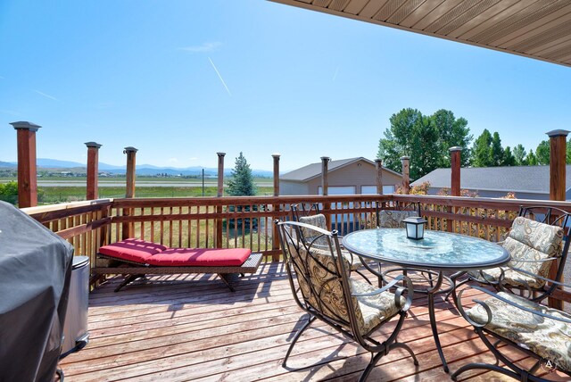 5835 Winter Wheat Dr, Helena, MT 59602 - wooden deck featuring outdoor dining area and a grill