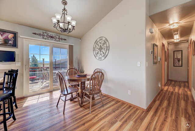 5835 Winter Wheat Dr, Helena, MT 59602 - dining room with light wood-type flooring, a chandelier, and vaulted ceiling