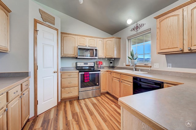 5835 Winter Wheat Dr, Helena, MT 59602 - kitchen featuring stainless steel appliances, light brown cabinetry, lofted ceiling, light wood-style floors, and light countertops