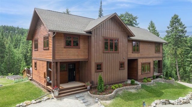 220 Cliff Creek Rd, Whitefish, MT 59937 - rustic home featuring board and batten siding, roof with shingles, and a front yard