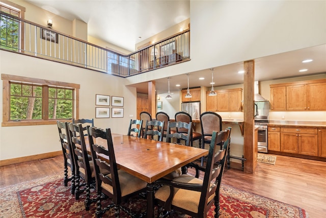 220 Cliff Creek Rd, Whitefish, MT 59937 - dining space with light wood-type flooring, a high ceiling, and recessed lighting