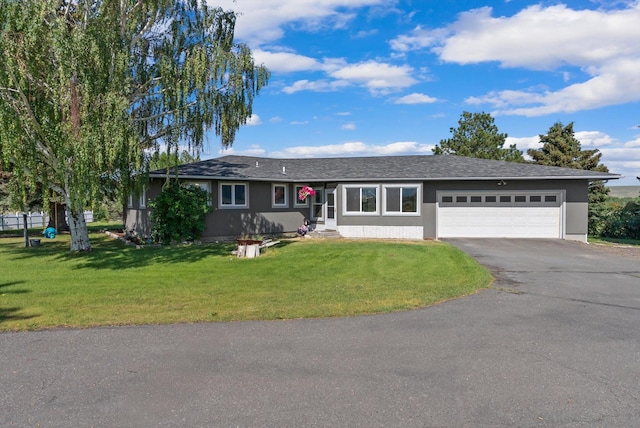 149 Meadow Vista Ln, Deer Lodge, MT 59722 - single story home featuring asphalt driveway, an attached garage, a front lawn, and stucco siding