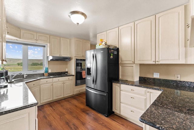 149 Meadow Vista Ln, Deer Lodge, MT 59722 - kitchen with fridge with ice dispenser, double oven, gas stovetop, under cabinet range hood, and dark wood finished floors