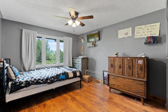149 Meadow Vista Ln, Deer Lodge, MT 59722 - bedroom with a textured ceiling, wood finished floors, and ceiling fan