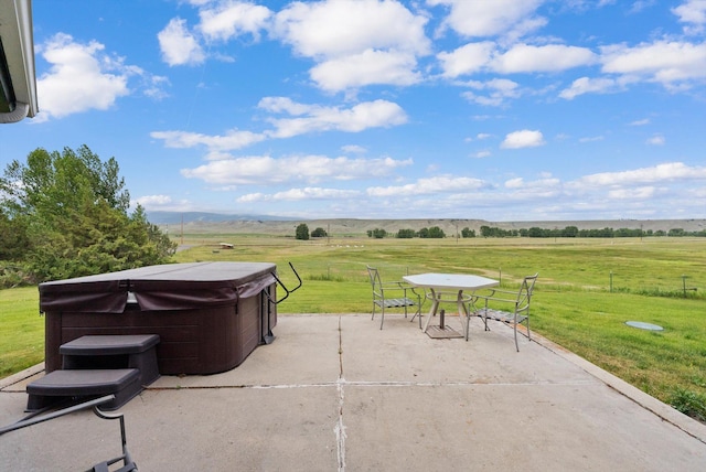 149 Meadow Vista Ln, Deer Lodge, MT 59722 - view of patio / terrace with a hot tub, a view of countryside, and outdoor dining space