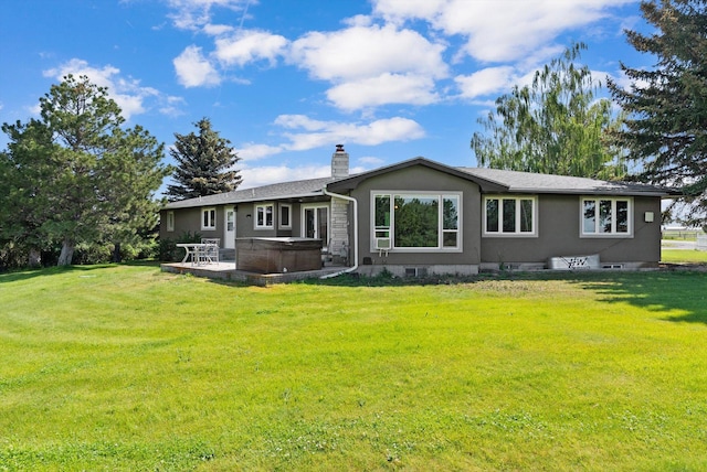 149 Meadow Vista Ln, Deer Lodge, MT 59722 - back of property featuring a hot tub, a chimney, a yard, and a patio