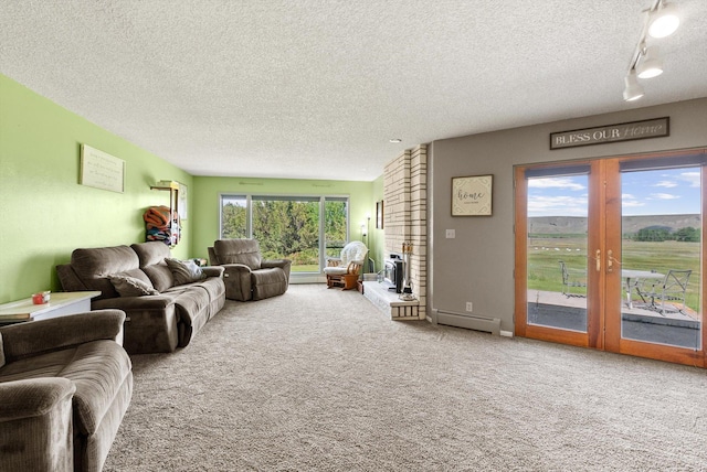 149 Meadow Vista Ln, Deer Lodge, MT 59722 - living area featuring a textured ceiling, carpet, and a baseboard heating unit