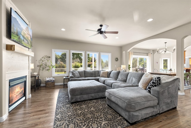 218 E Bowman Dr, Kalispell, MT 59901 - living room with arched walkways, a glass covered fireplace, a ceiling fan, wood finished floors, and recessed lighting