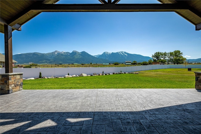 60951 Sparky Dr, Saint Ignatius, MT 59865 - fenced backyard featuring a mountain view and a patio