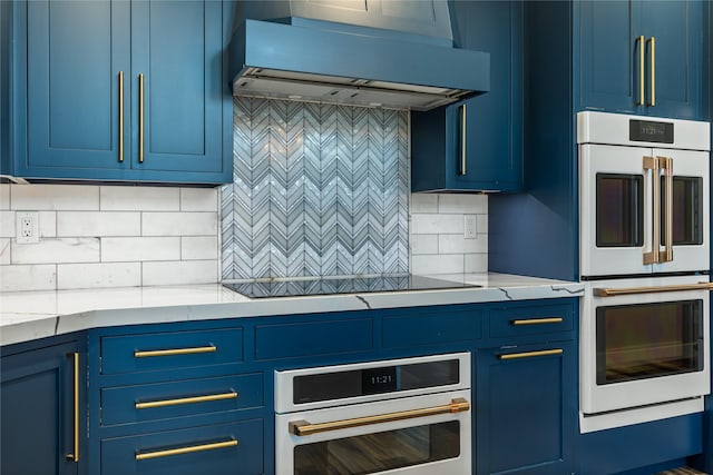 60951 Sparky Dr, Saint Ignatius, MT 59865 - kitchen with extractor fan, double oven, and blue cabinetry