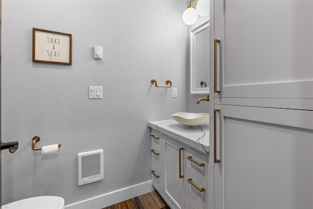60951 Sparky Dr, Saint Ignatius, MT 59865 - bathroom with vanity, heating unit, and wood finished floors