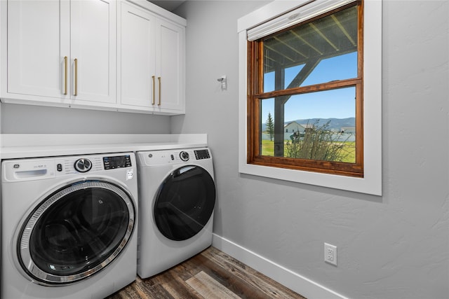 60951 Sparky Dr, Saint Ignatius, MT 59865 - laundry room with cabinet space, dark wood-style floors, washer and dryer, and a mountain view