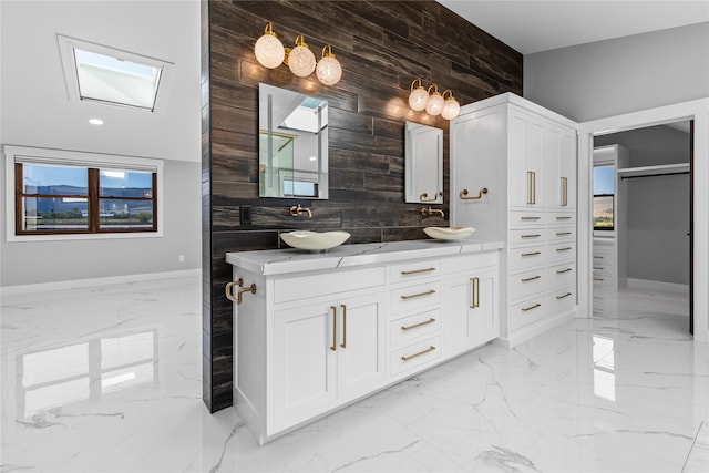 60951 Sparky Dr, Saint Ignatius, MT 59865 - full bathroom featuring marble tiled flooring, wooden walls, and double vanity