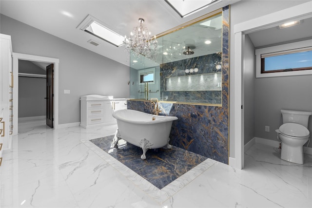60951 Sparky Dr, Saint Ignatius, MT 59865 - full bath featuring marble tiled flooring, a marble finish shower, a freestanding bath, a chandelier, and lofted ceiling