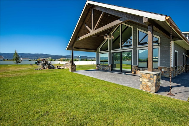 60951 Sparky Dr, Saint Ignatius, MT 59865 - view of grassy yard featuring a mountain view and a patio