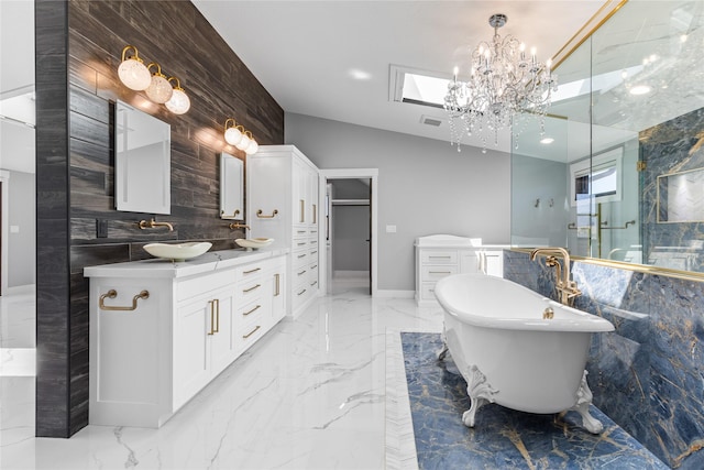60951 Sparky Dr, Saint Ignatius, MT 59865 - full bathroom with marble tiled floors, a freestanding tub, vanity, and a chandelier