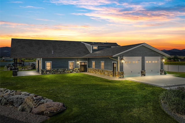 60951 Sparky Dr, Saint Ignatius, MT 59865 - view of front of property with an attached garage, stone siding, concrete driveway, and a shingled roof