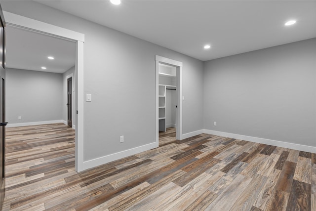 60951 Sparky Dr, Saint Ignatius, MT 59865 - unfurnished bedroom featuring recessed lighting, wood finished floors, a spacious closet, and a closet