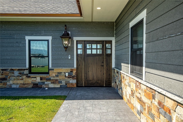 60951 Sparky Dr, Saint Ignatius, MT 59865 - property entrance featuring roof with shingles and stone siding
