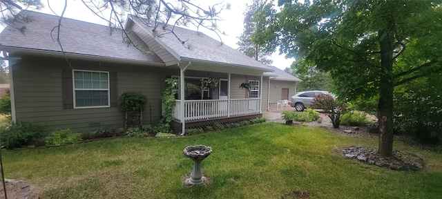 41052 Canyon View Dr, Polson, MT 59860 - view of side of property with covered porch, a yard, and roof with shingles