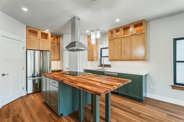 37 S Rodney St, Helena, MT 59601 - kitchen with wall chimney exhaust hood, stainless steel appliances, butcher block counters, wood finished floors, and recessed lighting
