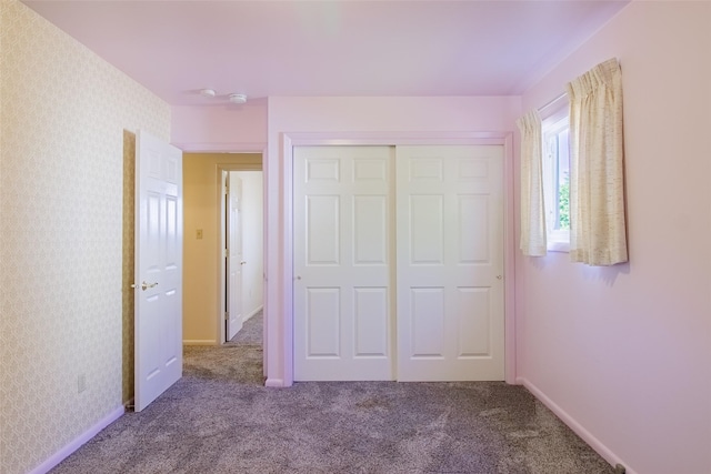 3455 N Hillcrest Dr, Butte, MT 59701 - unfurnished bedroom with carpet floors, a closet, and wallpapered walls