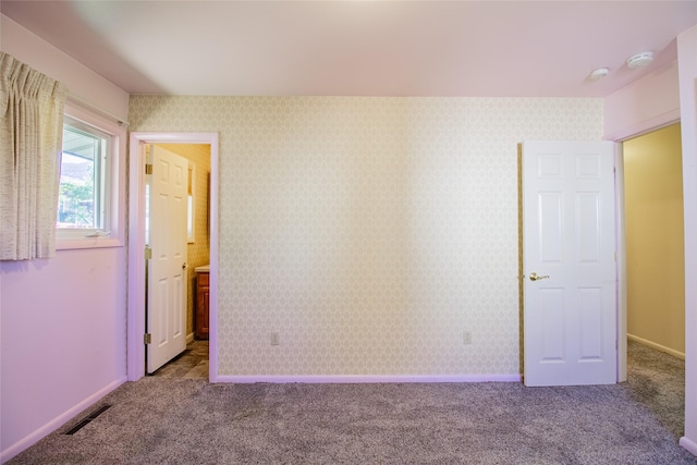 3455 N Hillcrest Dr, Butte, MT 59701 - unfurnished bedroom with dark colored carpet and ensuite bathroom