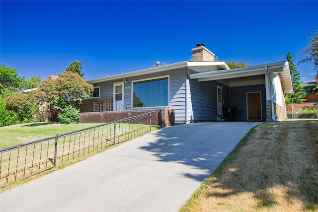 3455 N Hillcrest Dr, Butte, MT 59701 - single story home with concrete driveway, an attached carport, and a chimney