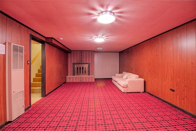 3455 N Hillcrest Dr, Butte, MT 59701 - unfurnished room featuring a heating unit, carpet flooring, wooden walls, stairway, and a fireplace
