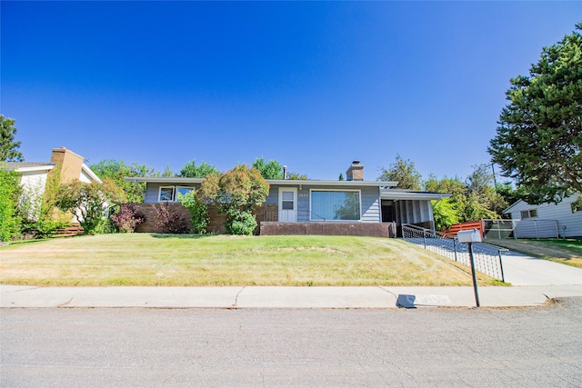 3455 N Hillcrest Dr, Butte, MT 59701 - view of front of home with a chimney, driveway, and a carport