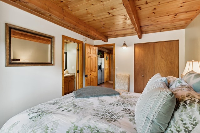 168 Carpenter Ln, Eureka, MT 59917 - bedroom with stainless steel fridge, a wood ceiling with exposed beams, a closet, and wood finished floors