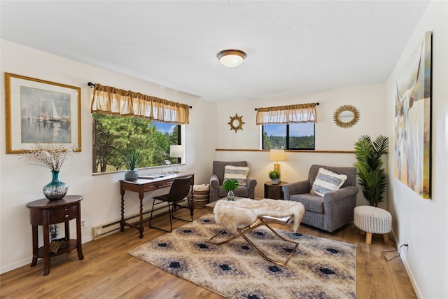 168 Carpenter Ln, Eureka, MT 59917 - sitting room with wood-type flooring, an office area, and a baseboard radiator