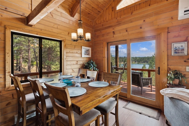 168 Carpenter Ln, Eureka, MT 59917 - dining area with vaulted ceiling, wood walls, wood-type flooring, a water view, and a chandelier