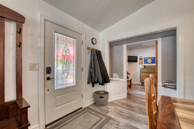 409 Mill Creek Rd, Hamilton, MT 59840 - entrance foyer with wood finished floors, healthy amount of natural light, and vaulted ceiling
