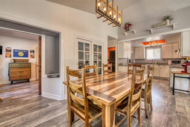 409 Mill Creek Rd, Hamilton, MT 59840 - dining space featuring dark wood-type flooring, a chandelier, washer / clothes dryer, and french doors