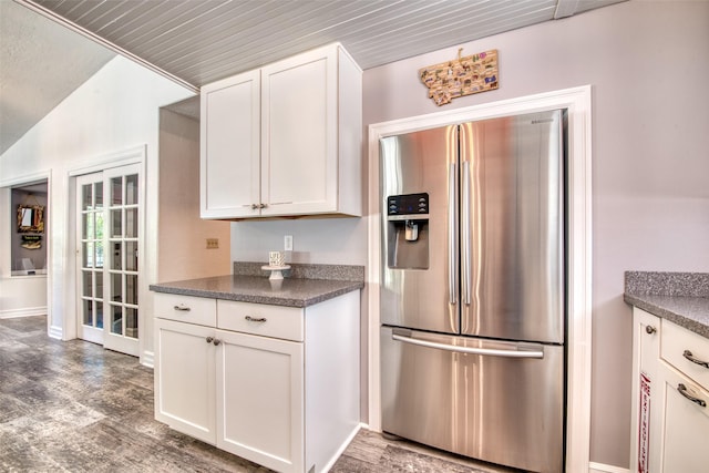 409 Mill Creek Rd, Hamilton, MT 59840 - kitchen with stainless steel refrigerator with ice dispenser, dark countertops, white cabinets, and wood finished floors
