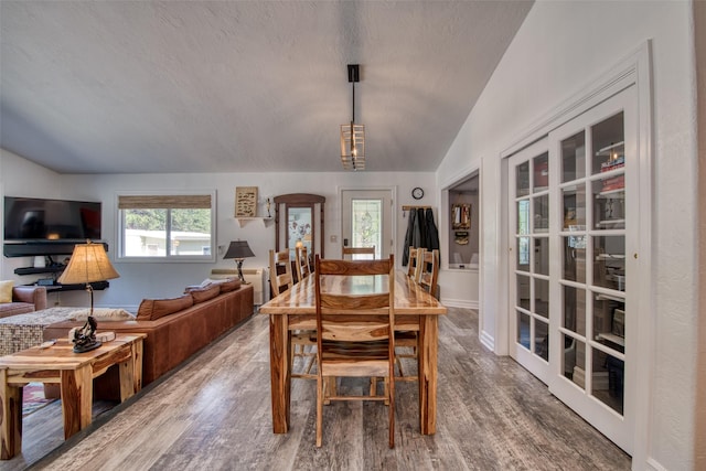 409 Mill Creek Rd, Hamilton, MT 59840 - dining area featuring vaulted ceiling, wood finished floors, and a textured ceiling