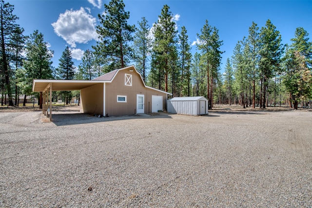 409 Mill Creek Rd, Hamilton, MT 59840 - view of home's exterior with a storage shed, a carport, and a metal roof