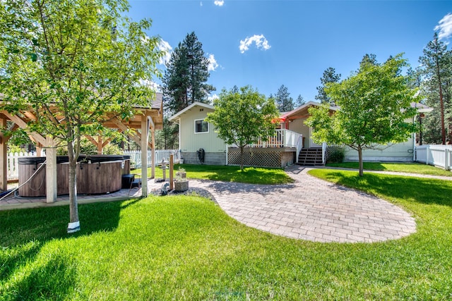 409 Mill Creek Rd, Hamilton, MT 59840 - fenced backyard with a hot tub, a wooden deck, and a patio area
