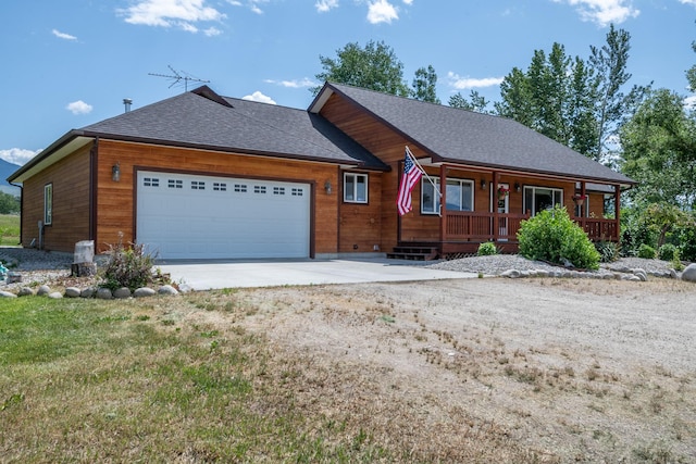 1228 Nordheim Ln, Corvallis, MT 59828 - view of front of property with a garage, concrete driveway, covered porch, and roof with shingles