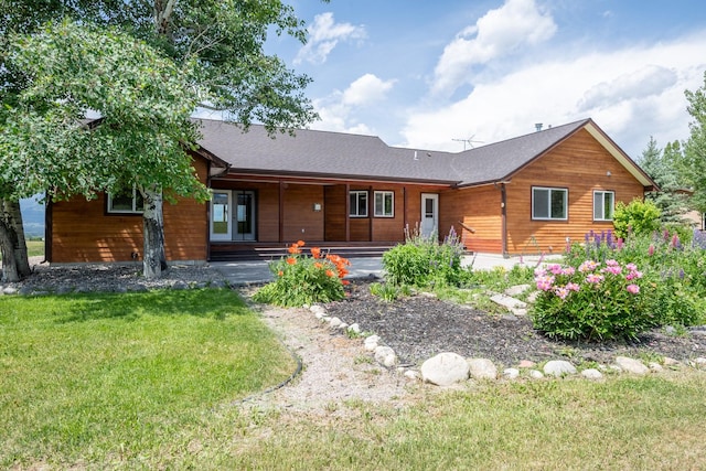 1228 Nordheim Ln, Corvallis, MT 59828 - back of house featuring a lawn and a shingled roof