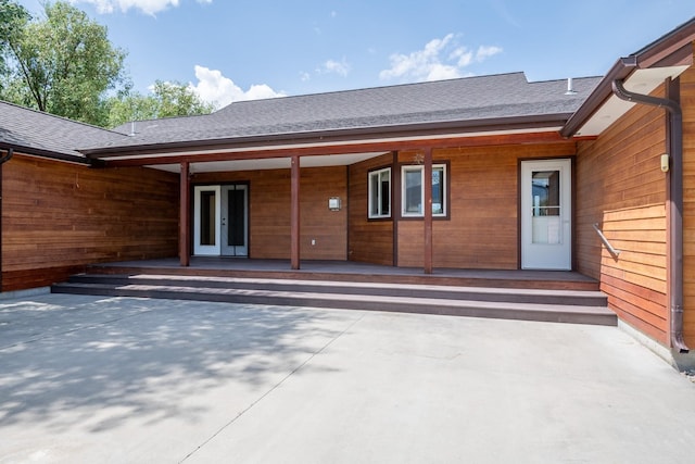 1228 Nordheim Ln, Corvallis, MT 59828 - back of property featuring french doors and a shingled roof