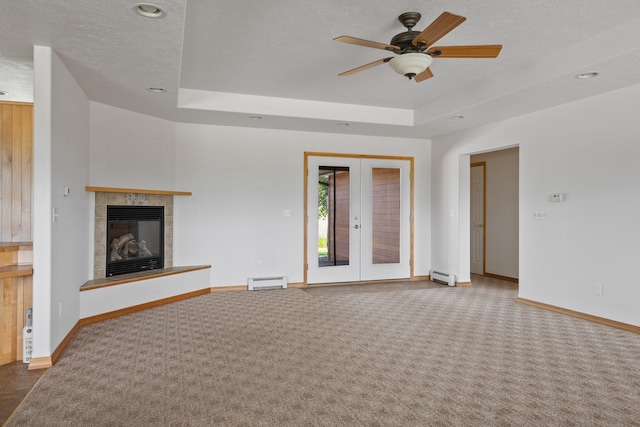 1228 Nordheim Ln, Corvallis, MT 59828 - unfurnished living room featuring a baseboard radiator, carpet, a ceiling fan, a raised ceiling, and recessed lighting