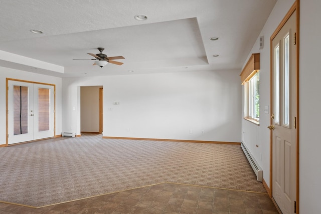 1228 Nordheim Ln, Corvallis, MT 59828 - carpeted spare room with a baseboard heating unit, a tray ceiling, a baseboard radiator, ceiling fan, and recessed lighting