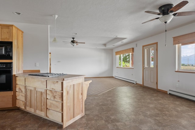 1228 Nordheim Ln, Corvallis, MT 59828 - kitchen with black appliances, a baseboard radiator, ceiling fan, light brown cabinets, and open floor plan