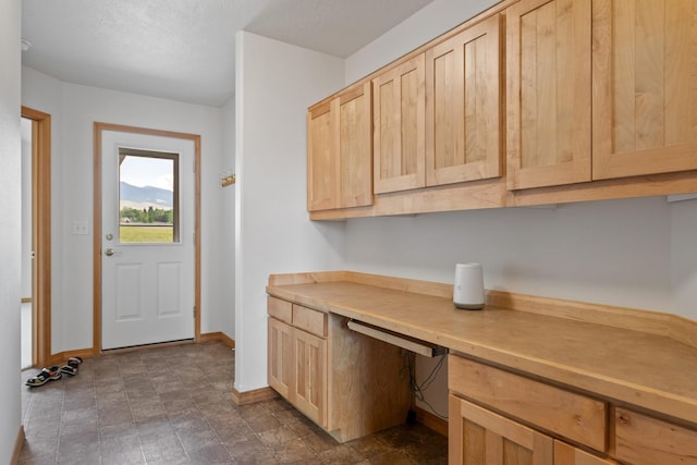 1228 Nordheim Ln, Corvallis, MT 59828 - laundry area featuring baseboards and a desk