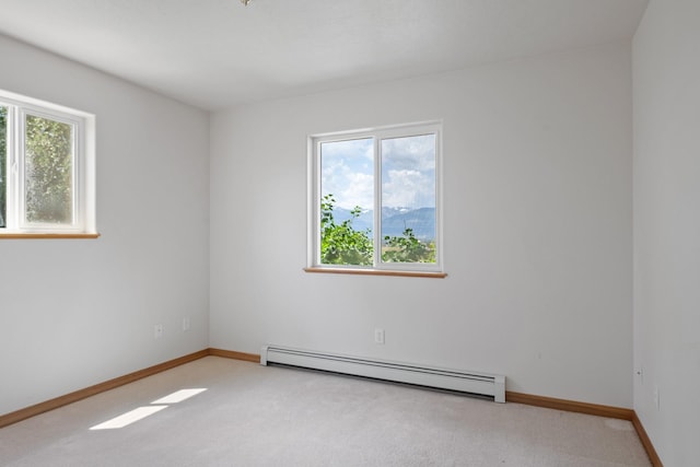 1228 Nordheim Ln, Corvallis, MT 59828 - empty room featuring a baseboard heating unit, healthy amount of natural light, and light colored carpet